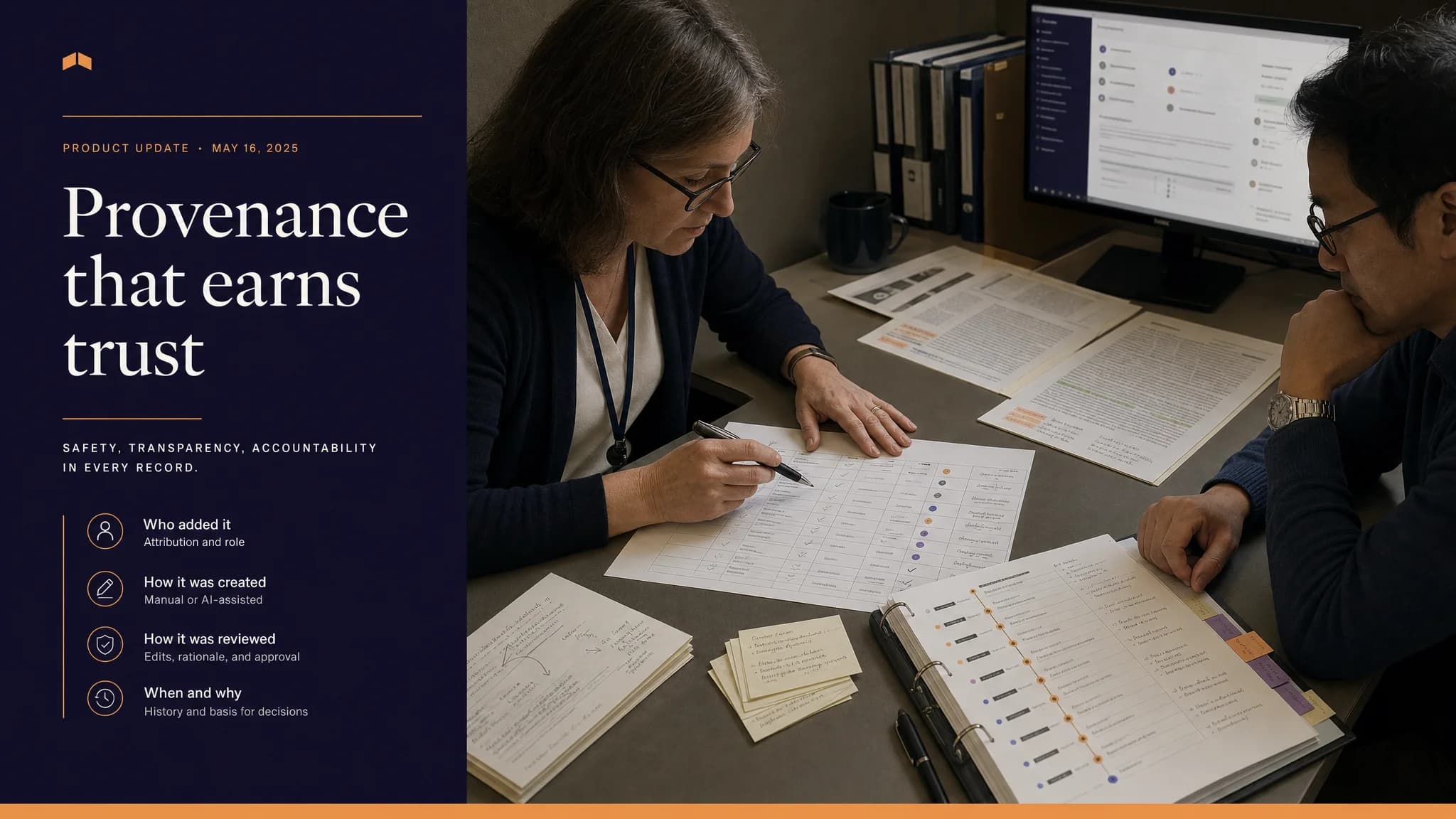 A woman reviews documents at a desk while a man observes, with a computer screen displaying information in the background.